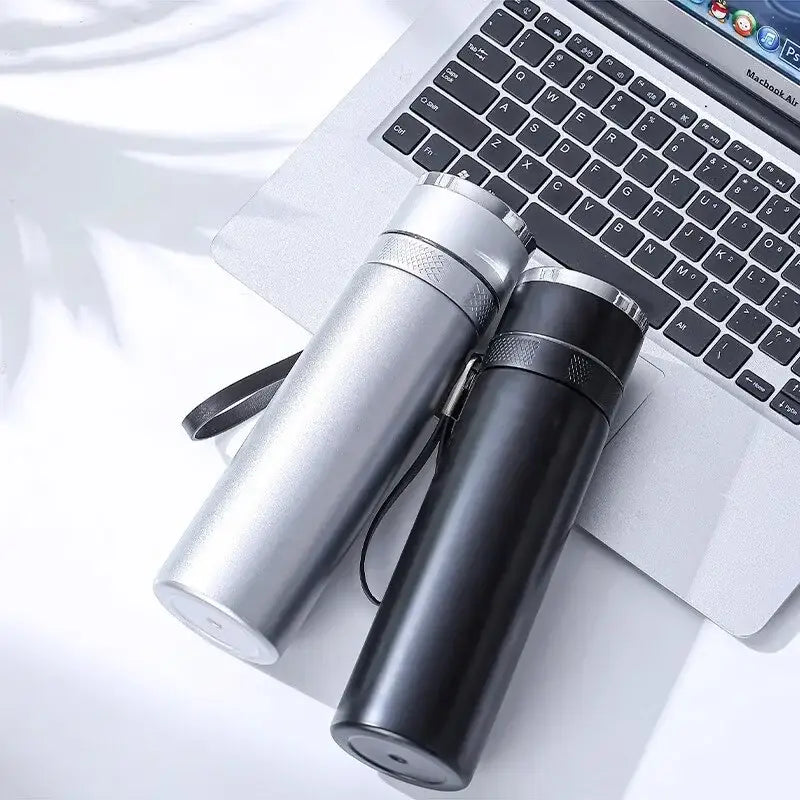 Two modern 400ml stainless steel vacuum travel mugs with black and silver finishes and textured grips with wrist straps