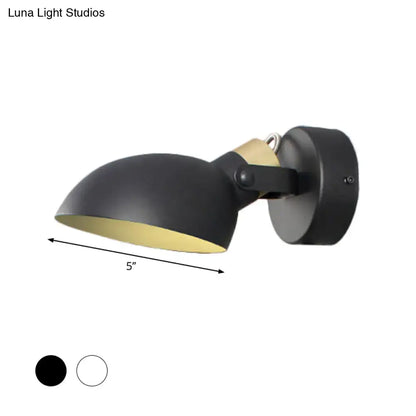 Modern style wall sconce light in black matte finish with gold interior and adjustable arm for bedroom illumination