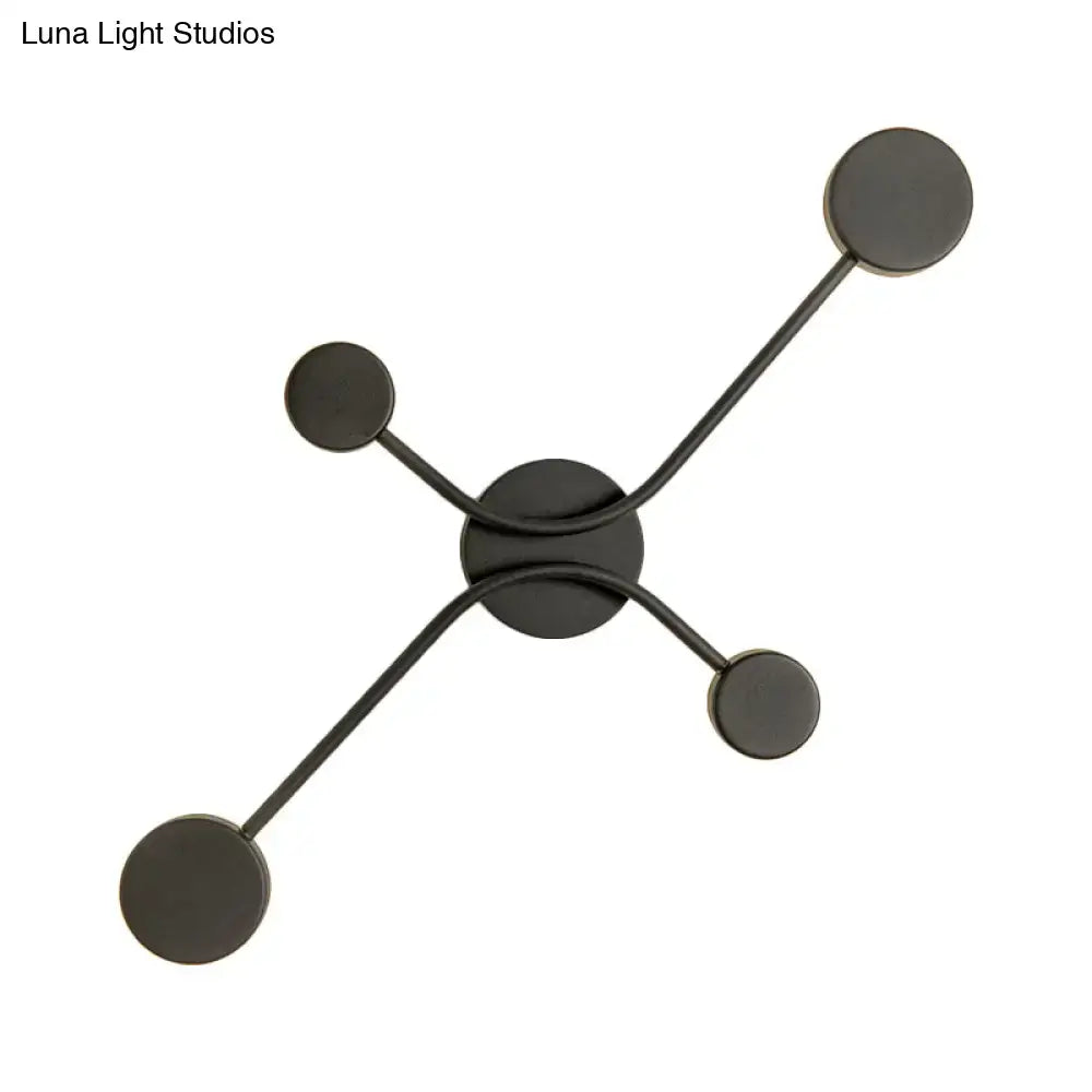 Modern black matte wall lamp with four circular LED lights arranged in a symmetrical star pattern for living room use