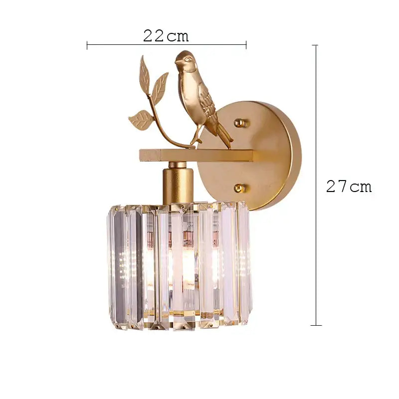 Gold-toned decorbites crystal bird wall lamp with bird on branch and cylindrical crystal shade for bedroom sconce decor