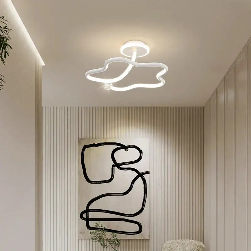 Modern white led ceiling light with sleek cloud-like design complementing decorbites black crystal chandelier