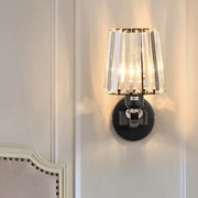 A sleek black wall light with cascading clear crystal design prisms for elegant living room illumination