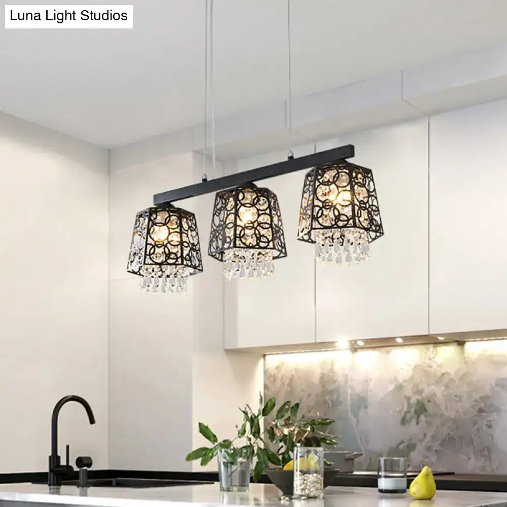 Modern black wrought iron light fixture chandelier with crystal droplet accents and ornate metalwork shade shape