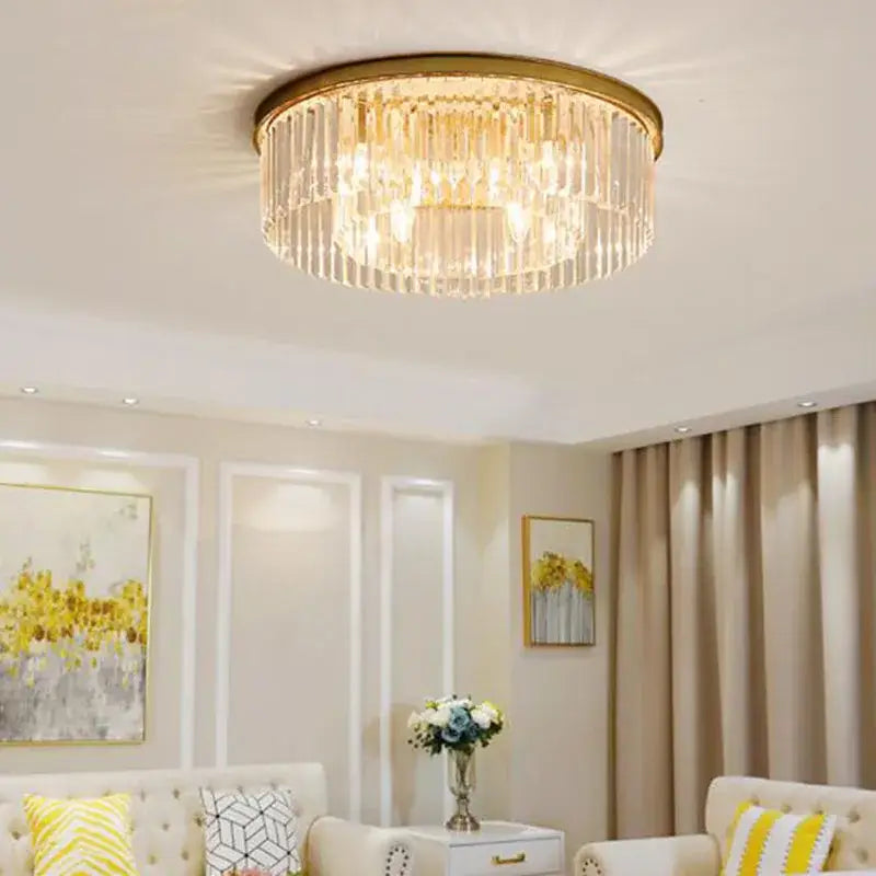 Gold-toned flush mount ceiling light with cascading clear crystal rods for modern dining room chandelier lighting