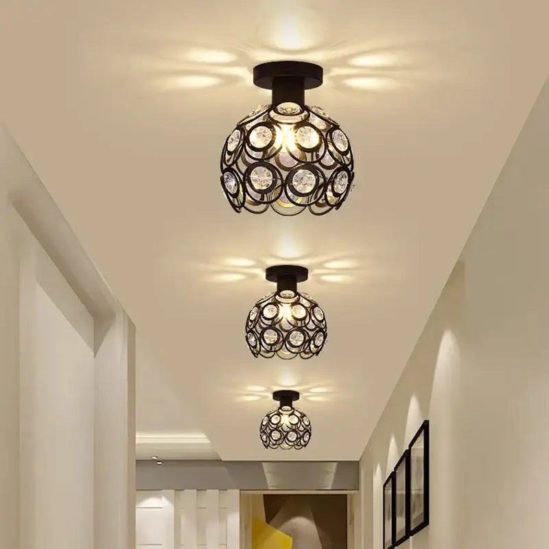 Modern black metal ceiling light fixture with spherical design and multiple clear crystal circles decorbites crystal flush mount