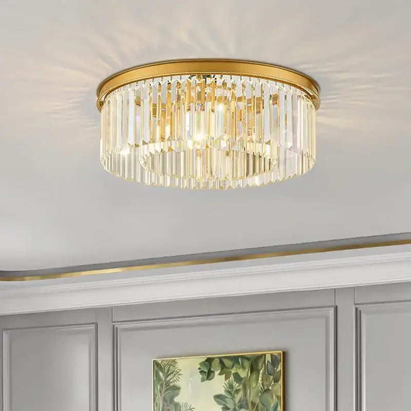 Modern black crystal flush mount ceiling light with gold-toned metal frame and cascading clear crystal prisms decorbites crystal flush