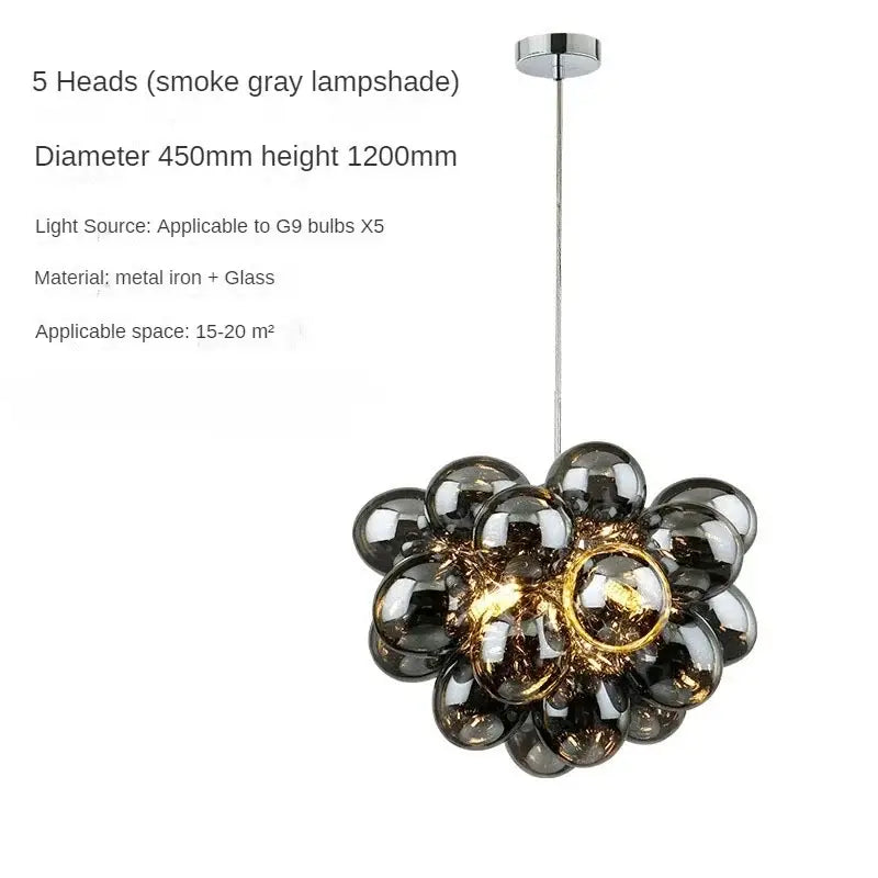 A modern decorbites crystal grape chandelier with five smoke gray glass orbs hanging from a chrome canopy