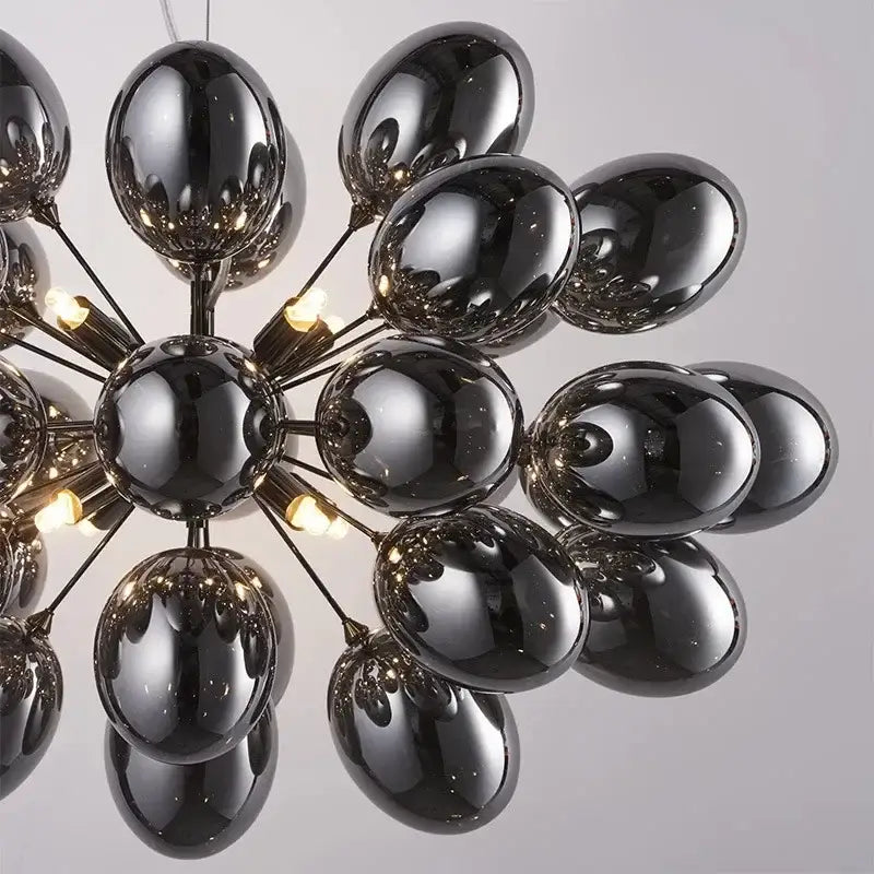 Modern black crystal grape chandelier with glossy glass globe, metallic arms, and warm light bulbs for dining room decorbites crystal grape