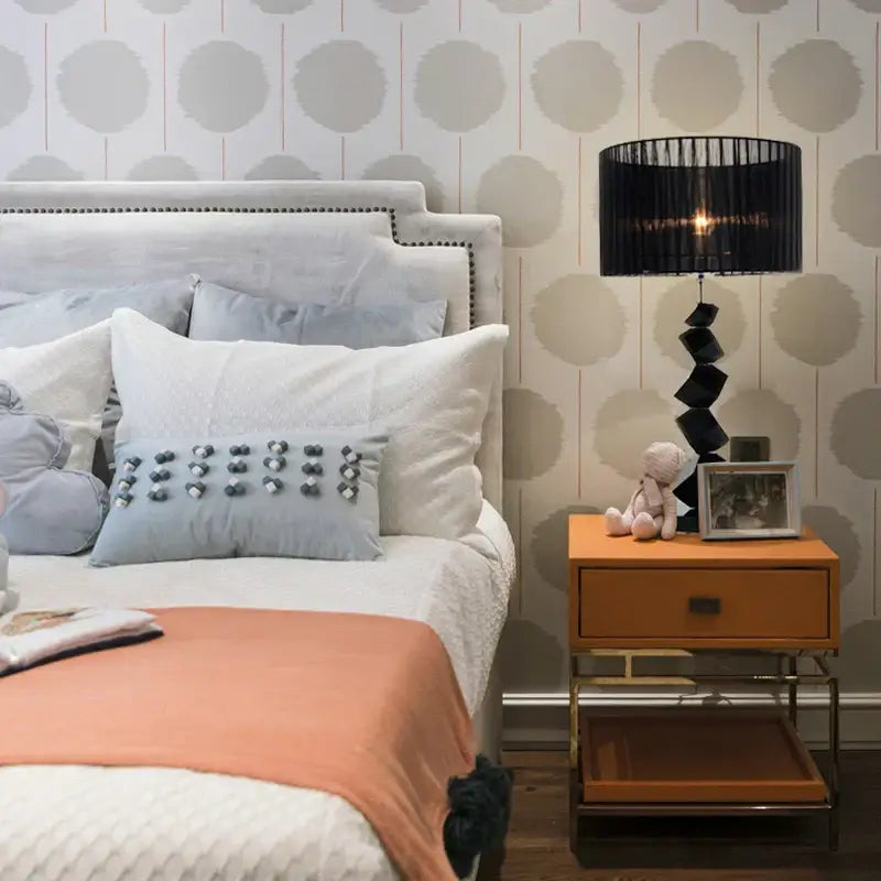Modern black crystal table lamp with pleated ribbed shade and geometric black crystal base on orange nightstand chrome legs