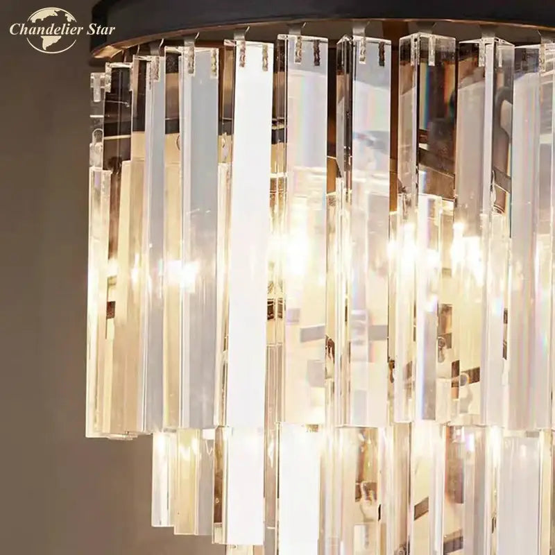 Modern black crystal wall lamp with clear and smoked glass featuring cascading prisms and warm glowing lights for decorbites