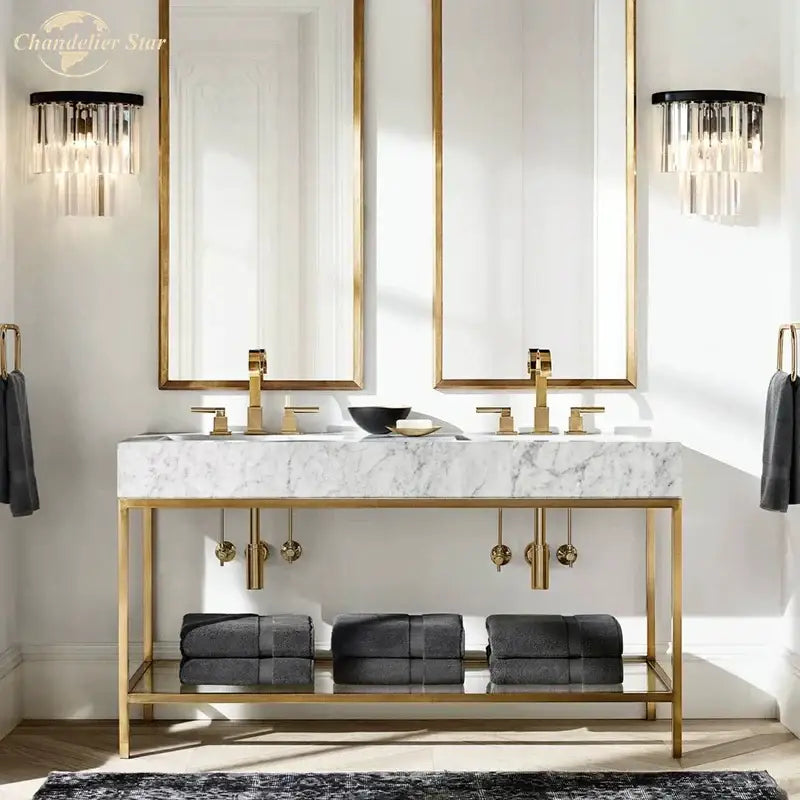 Modern black crystal wall lamp with clear and smoked glass above gold-framed double vanity and marble countertop decorbites crystal wall lamp