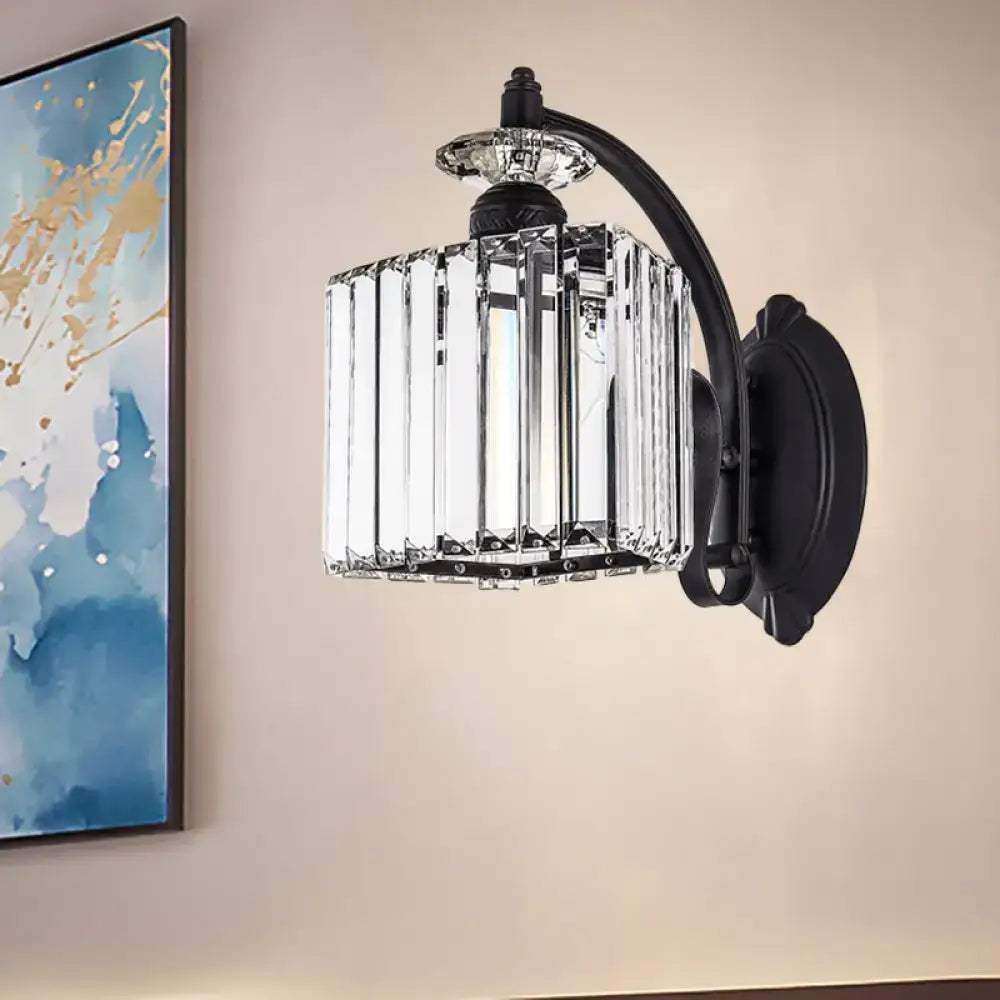 Modern style black wrought iron wall light with curved arm and cylindrical crystal cage for living room use