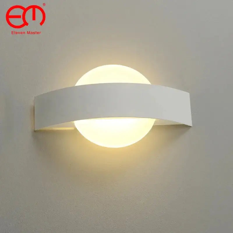 Modern black curved led wall light with white minimalist rectangular frame and circular frosted glass diffuser emitting warm light