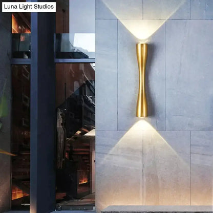 Gold-toned sleek curved wall sconce with modern design suitable as a black outdoor waterproof porch light