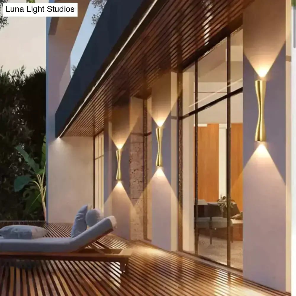 Gold-toned modern black curved wall sconce with sleek design for outdoor waterproof porch lighting