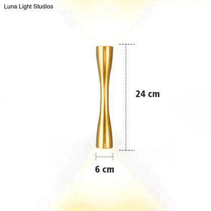 A sleek 24 cm tall gold-toned metallic floor lamp with a slender hourglass design shown with a modern black curved wall sconce outdoor waterproof porch light