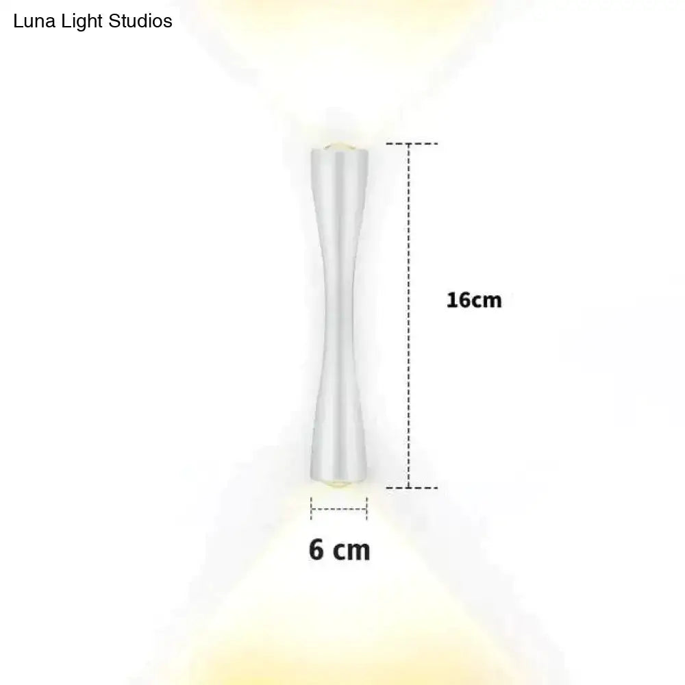 A sleek 16cm tall white led wall sconce with modern hourglass silhouette and smooth metallic finish for outdoor use