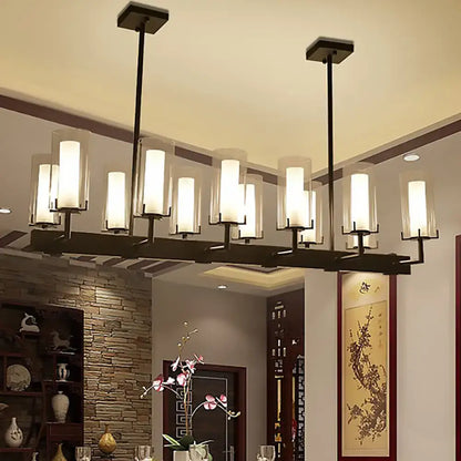 Modern black metal chandelier with multiple frosted cylinder clear glass shades for clear glass island lighting