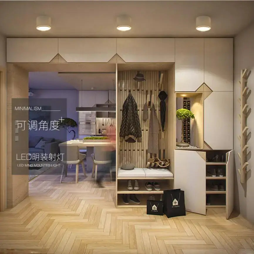 Minimalist wooden shoe storage unit with integrated coat rack and bench shown under modern black cylindrical dimmable ceiling spot light