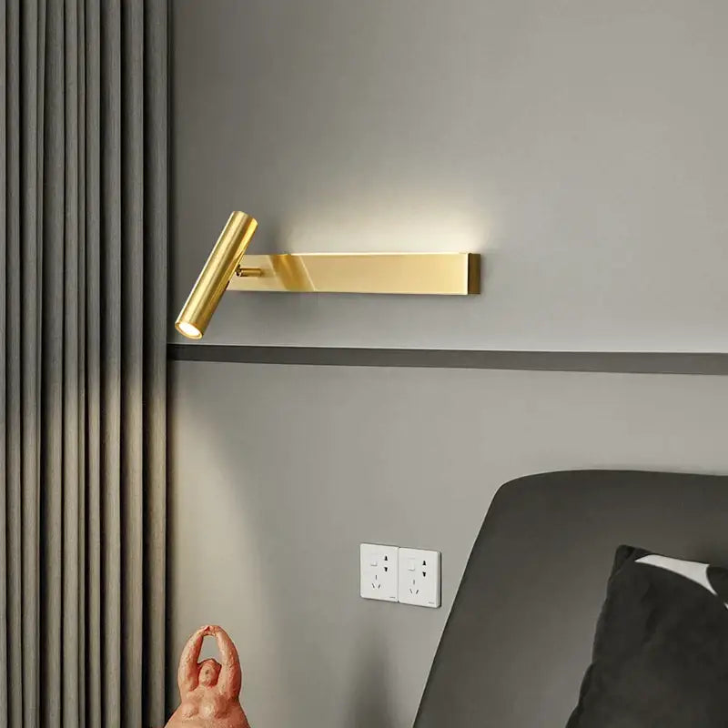 Modern black cylindrical wall light with gold-colored copper finish and adjustable arm for bedroom reading decorbites copper wall light