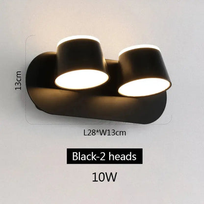 Modern black decorbites adjustable led wall lamp with two cylindrical heads emitting warm white illumination for bedroom