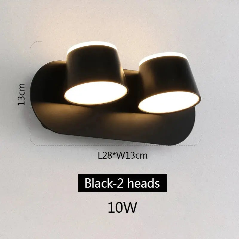 Modern black decorbites adjustable led wall lamp with two cylindrical heads emitting warm white illumination for bedroom