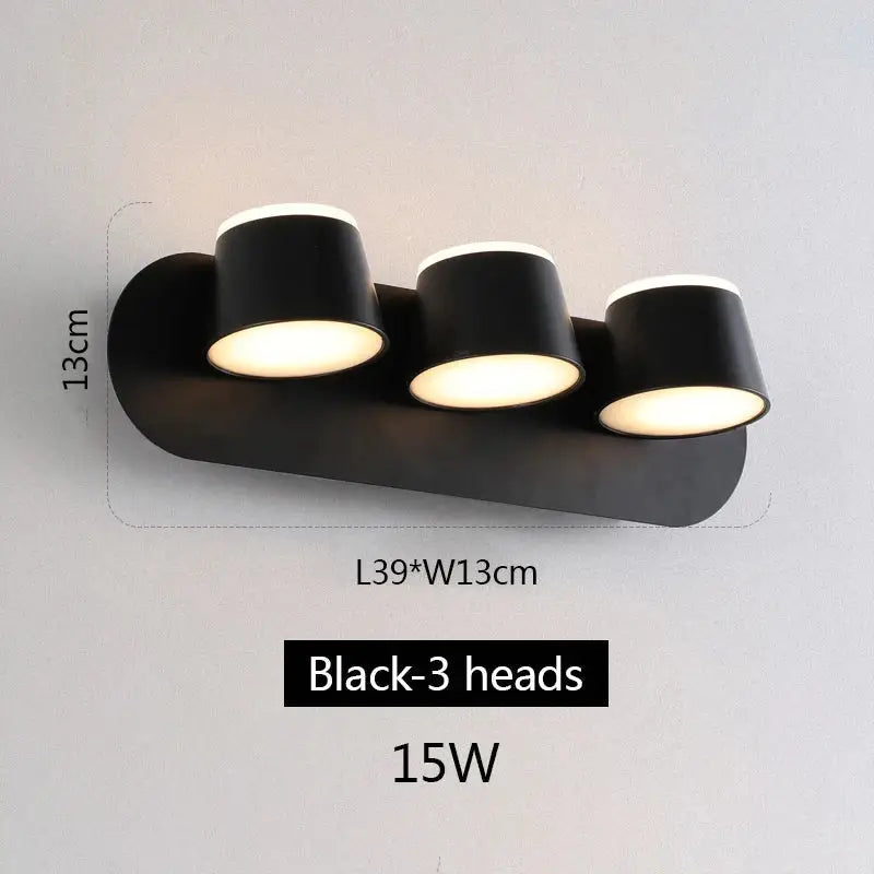 Modern black decorbites adjustable led wall lamp with three cylindrical heads emitting warm white light for bedroom use