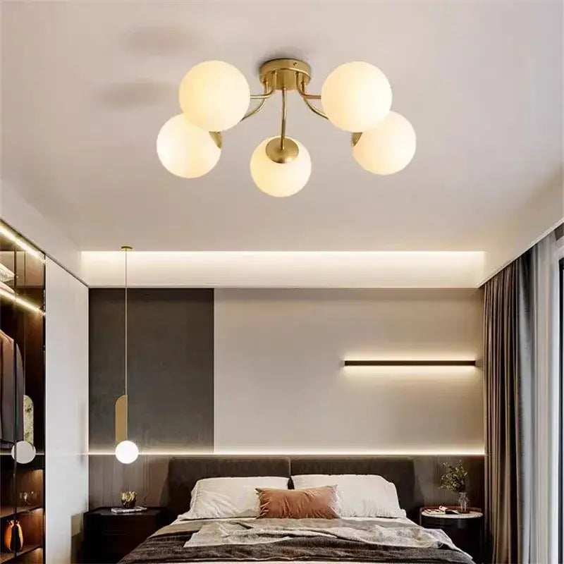 Gold-toned ceiling light with five frosted decorbites bubble glass globe shades for modern living room lighting