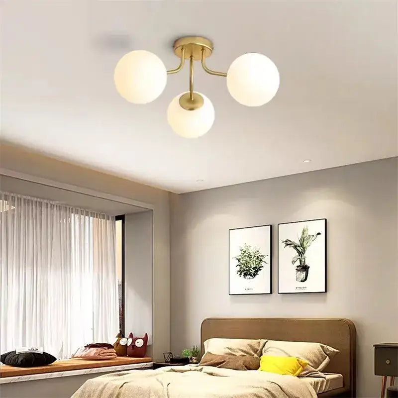 Gold-toned decorbites bubble glass led ceiling light with three frosted white spherical shades for modern living room