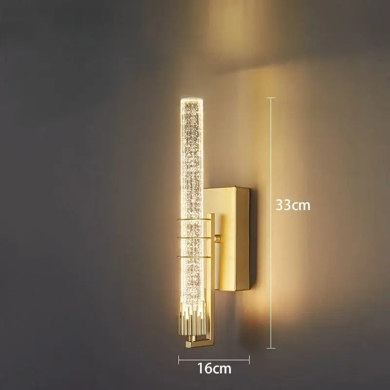 Modern black decorbites crystal wall led sconce with a gold-toned cylindrical crystal-encrusted light tube and metallic bracket