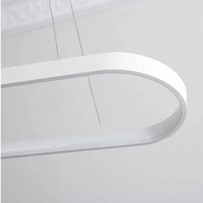 A sleek modern white led pendant lamp with a minimalist curved design by decorbites designer oval for dining room