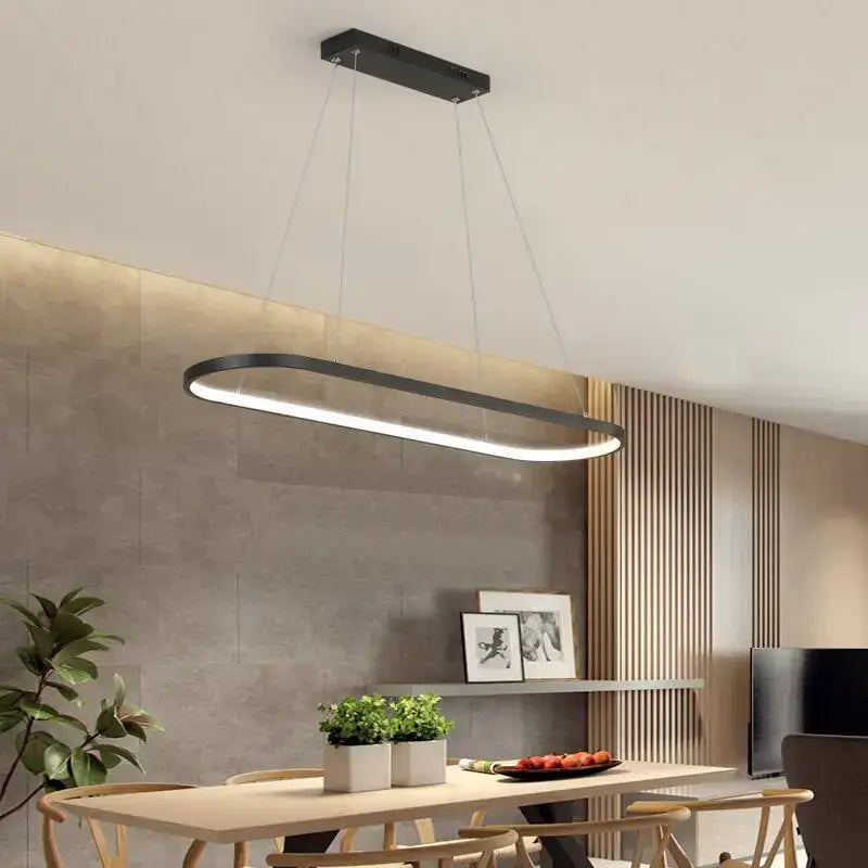 Modern black decorbites designer oval pendant lamp with sleek minimalist design hanging above dining table