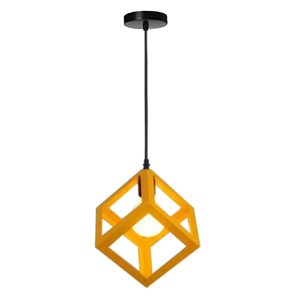 A modern yellow cube-shaped decorbites geometric led pendant light with black ceiling mount and cord for kitchen use