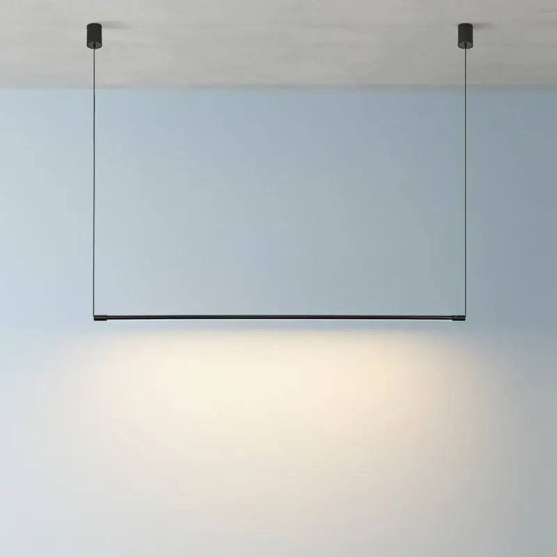 Minimalist black dimmable led pendant light with sleek linear design hanging by thin cords for dining room decorbites