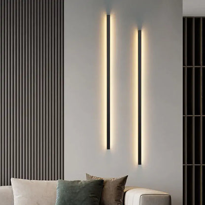 Two sleek black decorbites dimmable long wall lamps emit warm ambient lighting for modern bedroom wall lamp decor