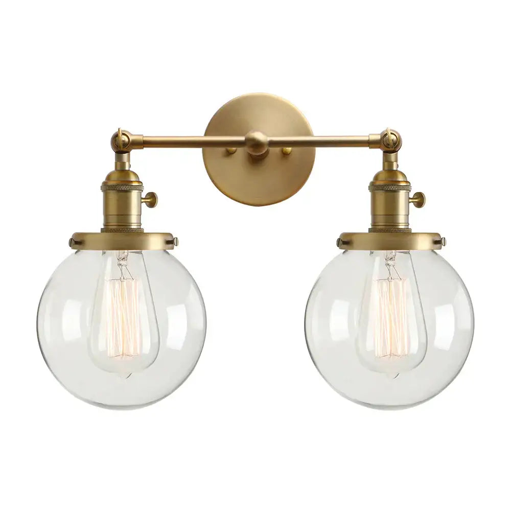 Brass-finished modern wall sconce with double ball heads globe glass shades and vintage edison bulbs for bedroom lighting