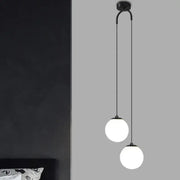 Modern black double glass ball pendant light featuring two frosted glass globes on a curved arm for bedroom ceiling