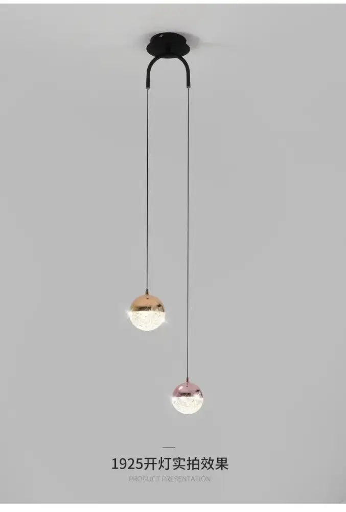 Modern black double glass ball pendant light with spherical frosted glass shades in rose gold and brass finishes for bedroom ceiling