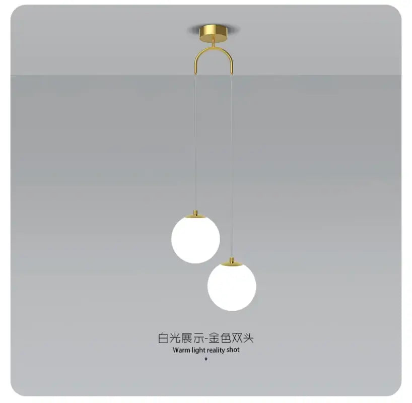 Gold-toned ceiling-mounted pendant light with double glass ball white shades for modern bedroom lighting