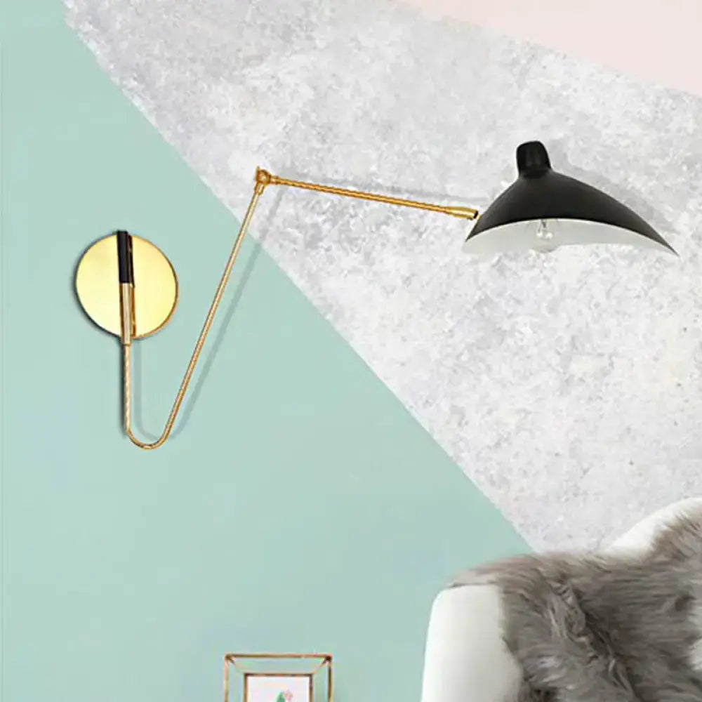 Black and gold modern wall lamp with duckbill shade and curved arm articulated for bedroom use