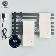 Modern black electric towel warmer rack with digital temperature display and two beige textured towels hanging on it