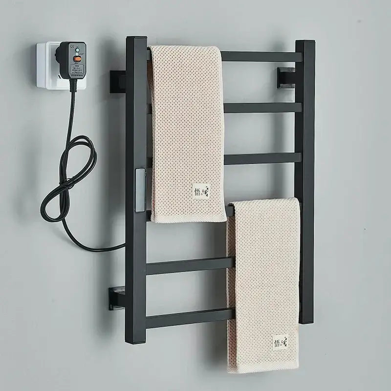 Modern black electric towel warmer with digital display featuring a heated metal rack and two beige textured towels hanging