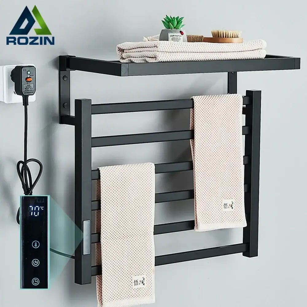 Modern black electric towel warmer with integrated shelf and digital temperature control for bathroom use