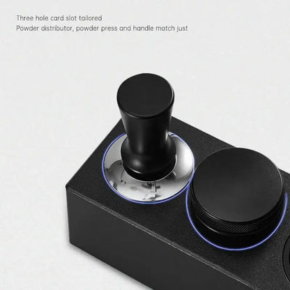 Modern black espresso tamper with sleek cylindrical handle and polished base on decorbites espresso tamper station
