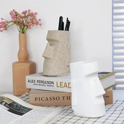 Beige stone-textured moai head resin desktop organizer pen holder with black pens by decorbites desktop organizer