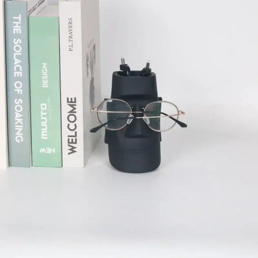 Modern black face desktop organizer in matte ceramic resin by decorbites holding glasses and pens for office use