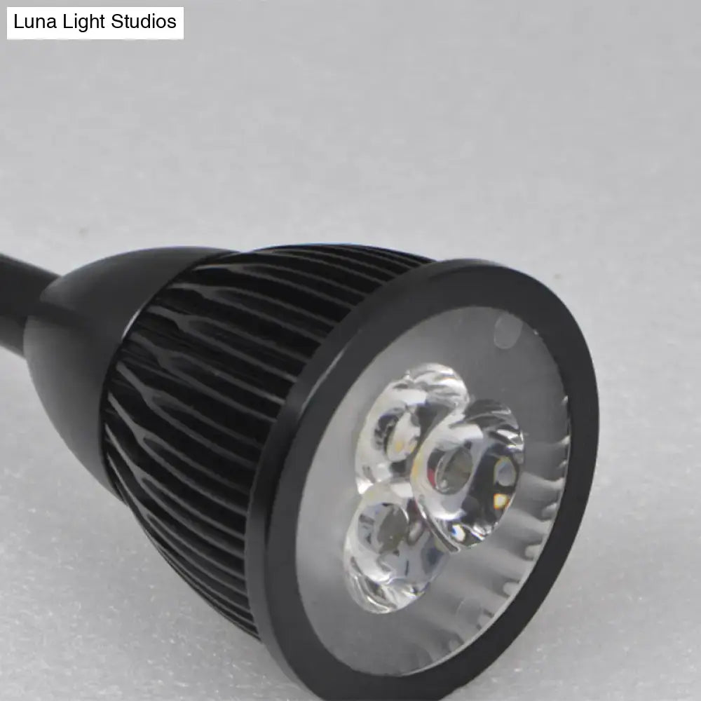 Modern black finish metal shade wall lamp with led spotlight featuring ribbed heat sink and warm white light