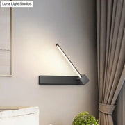 Modern black finish rotatable led wall sconce with sleek angular design and warm white light for bedroom lighting