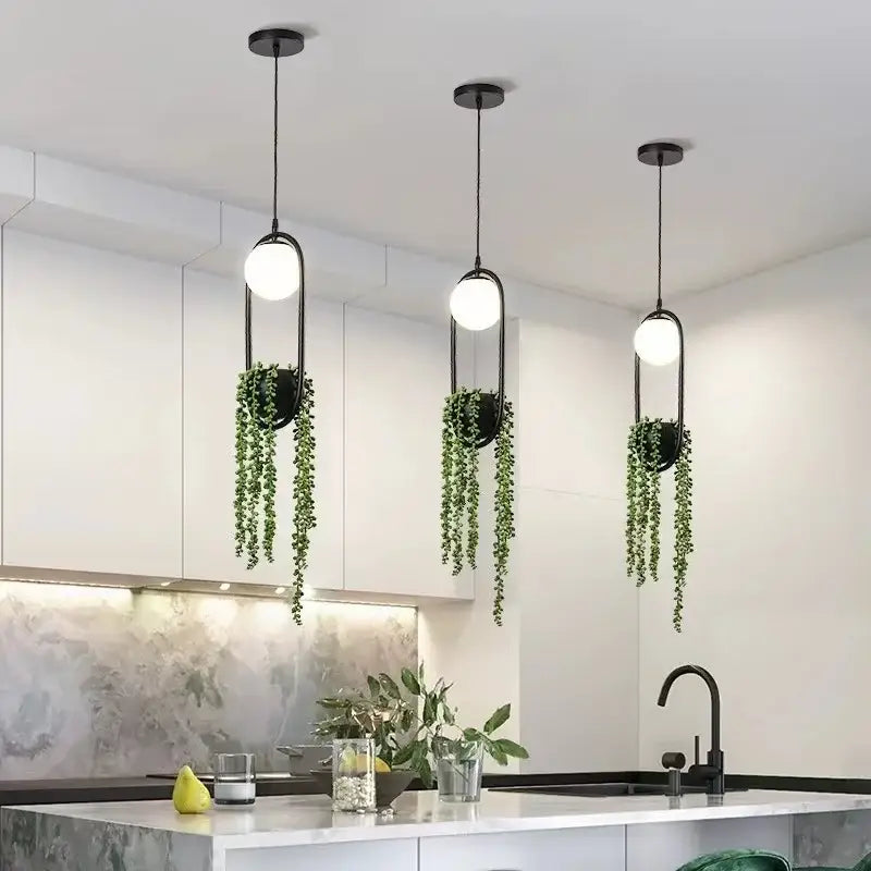 Modern black flower pot pendant lights with sleek oval frames and green trailing plants for dining room decorbites decor