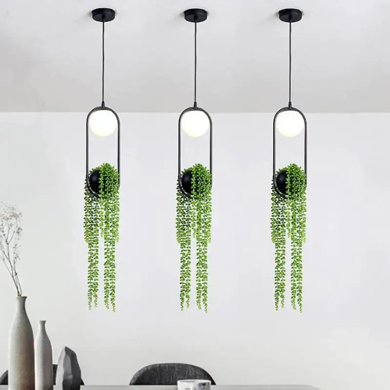 Modern black flower pot pendant lights with spherical bulbs and trailing green plants for dining room decorbites decor